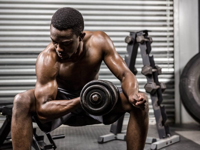 shirtless-man-lifting-dumbbell-on-bench-at-the-PQVL8YF-min.jpg